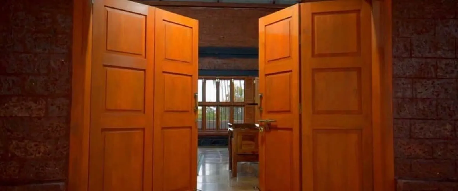 Carved teak doors opening into the Wada